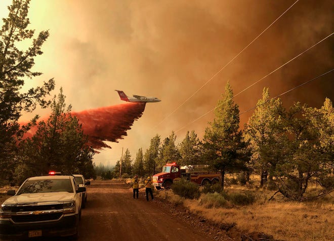 SISTERS, OREGON - JULY 11: In this handout provided by the Oregon Department of Forestry, a firefighting tanker drops retardant over the Grandview Fire on July 11, 2021 northeast of Sisters, Oregon. The Grandview Fire had spread to nearly 6,000 acres before firefighters, aided by calmer winds, were able slow it at 10 percent contained amid dozens of blazes burning in the western U.S. fueled by record temperatures and drought.