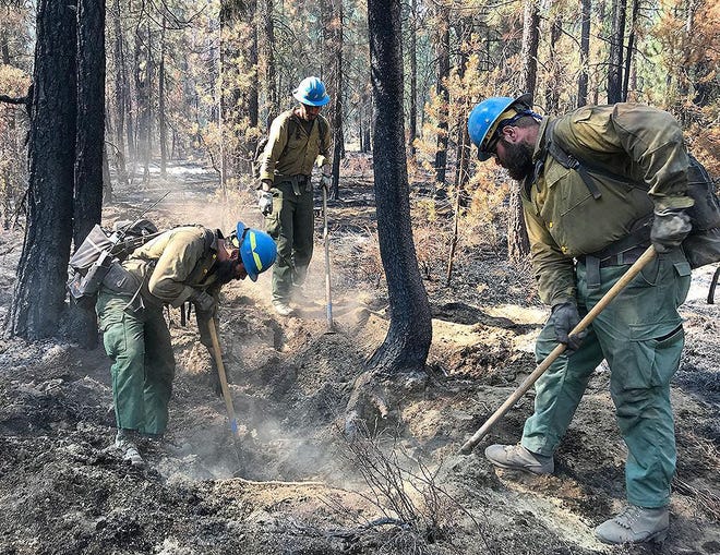 BLY, OREGON - JULY 14: In this handout provided by the USDA Forest Service, firefighters work to control the Bootleg Fire on July 14, 2021 in Bly, Oregon. The Bootleg Fire has has spread over 212,377 acres, making it the largest among the dozens of blazes burning in the western U.S. fueled by record temperatures and drought.