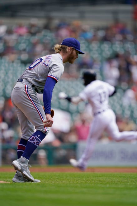 Rangers starting pitcher Mike Foltynewicz walks off the mound as the Tigers' Eric Haase rounds the bases on his three-run home run to left field during the first inning.