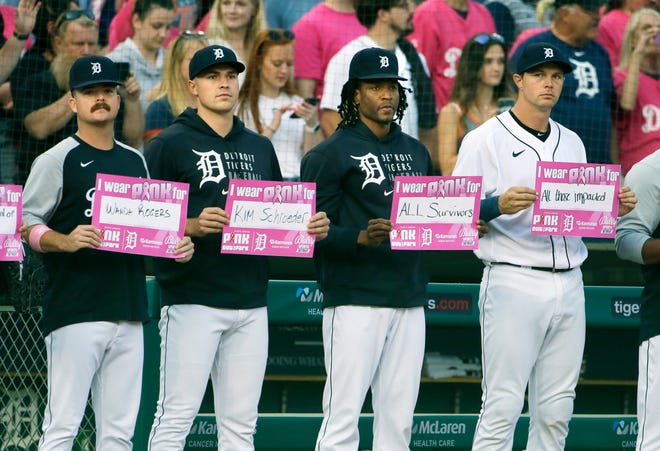 Tigers'  (L-R) Jake Rogers, Tarik Skubal, Gregory Soto and Grayson Greiner hold up placards for cancer awareness night during Pink Out the Park.