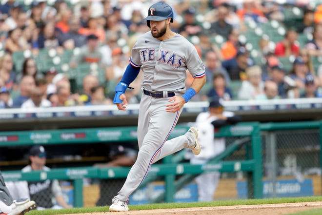 The Rangers' Joey Gallo scores in the sixth inning.