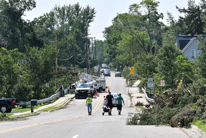The view down West Main Street. A mix of volunteers and work crews clean up the area after Saturday's tornado in Armada, Michigan, on July 26, 2021.