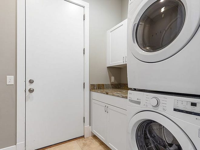 Main floor laundry and second laundry with a washer and two dryers in fully finished basement.