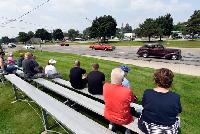 Cruisers head northbound on Gratiot Avenue, as onlookers admire their their vehicles, during the 18th annual Clinton Township Gratiot Cruise, Sunday, Aug. 1, 2021 in Clinton Township, Mich.
