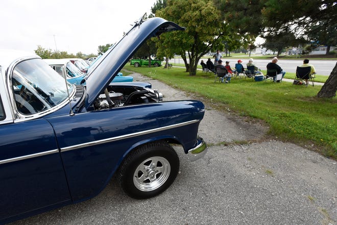 Visitors wait for the start of the 18th annual Clinton Township Gratiot Cruise, Sunday, Aug. 1, 2021 in Clinton Township, Mich.  In the foreground is a 1955 Bel Air.