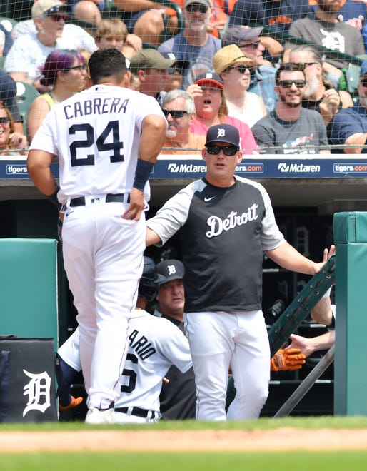 Tigers manager AJ Hinch greets Miguel Cabrera after Cabrera scores in the first inning.