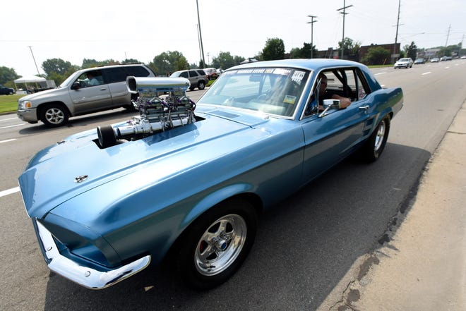 A 1967 Mustang owner prepares to drive northbound on Gratiot during the 18th annual Clinton Township Gratiot Cruise, Sunday, Aug. 1, 2021 in Clinton Township, Mich.