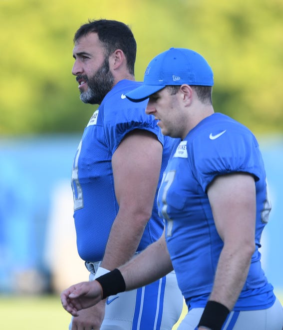 Lions long snappers Don Muhlbach, an 18-year veteran, and Scott Daly, a second-year pro, head out to the practice field.