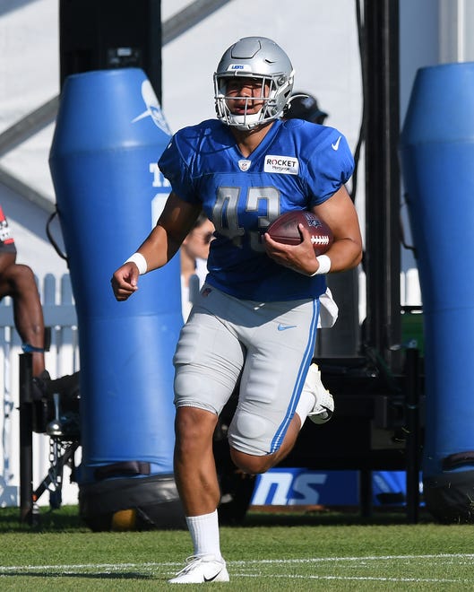 Lions tight end Charlie Taumoepeau runs up field after a reception during drills.