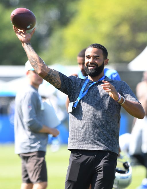 Tigers center fielder Derek Hill throws the football around during a visit to Lions training camp.