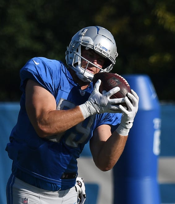 Lions tight end Brock Wright hangs onto a reception during drills.