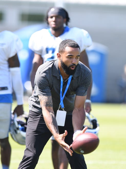 Tigers center fielder Derek Hill reaches down for a reception during a visit to Lions training camp.