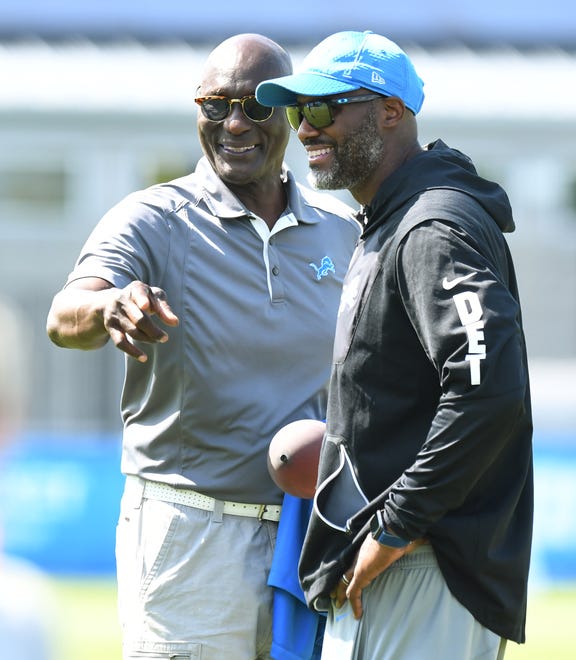 Luther Bradley, a former first-round draft pick of the Lions, talks with his nephew Brad Holmes, the Lions' GM, on the field after training camp.