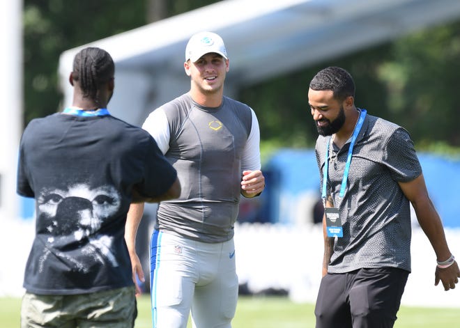 Lions quarterback Jared Goff talks with Tigers outfielders Akil Baddoo and Derek Hill after training camp.