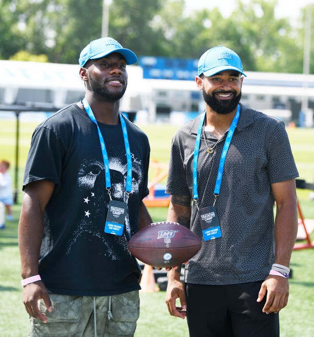 Tigers outfielders Akil Baddoo, left, and Derek Hill visit Lions training camp.