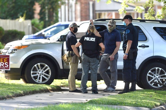 Investigators outside of the Detroit home of Janee Ayers as it was searched by the FBI in Detroit onWednesday, August 25, 2021.