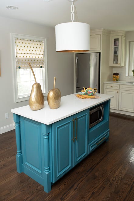 The ranch-style house with a finished walkout had been partially remodeled by the previous owners. Recent updates by the couple include the Caribbean blue paint that refreshed the kitchen island and new hardware for the cabinetry.
