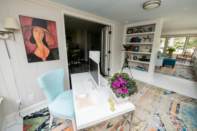 Like the rest of the house, Anne’s office in the sunroom features a mix of pieces from previous homes and recent finds. A built-in bookcase holds decorative accents and family photos.