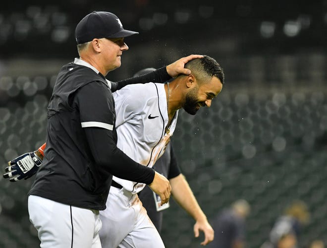 Tigers manager AJ Hinch reacts with Derek Hill after Hill's walk off RBI double to win in the eleventh inning.
