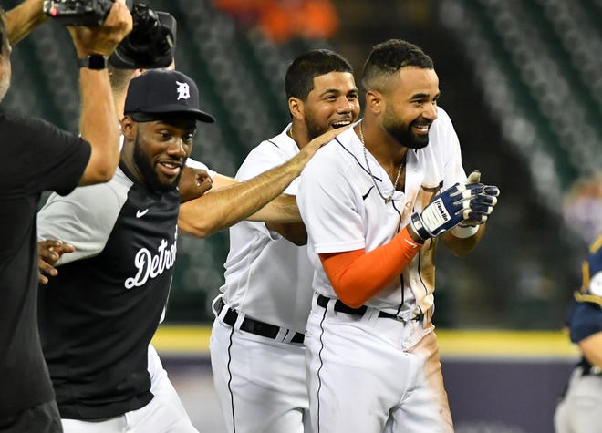 From left, Tigers' Akil Baddoo and Jeimer Candelario celebrate with Derek Hill after Hill's  walk off RBI double to win in the eleventh inning.   Detroit Tigers vs Milwaukee Brewers at Comerica Park in Detroit on Sept. 14, 2021.