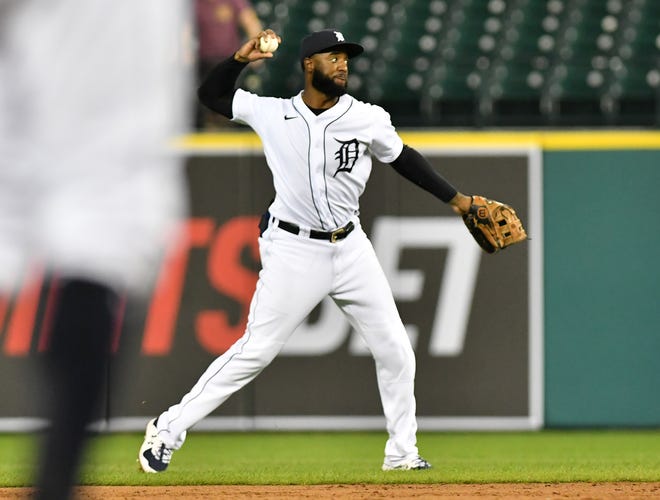 Tigers shortstop Niko Goodrum makes a throw to first in the eleventh inning.