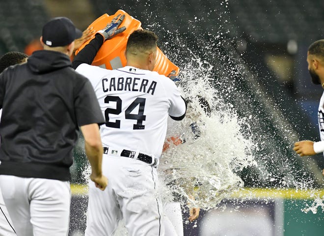 Tigers' Miguel Cabrera heaps the cold water on Derek Hill after Hill's walk off RBI double to win in the eleventh inning.