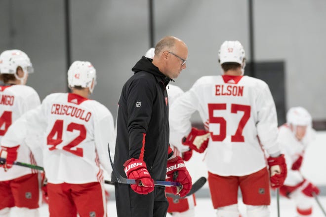 Head coach Jeff Blashill skates past some of the players during Red Wings training camp.