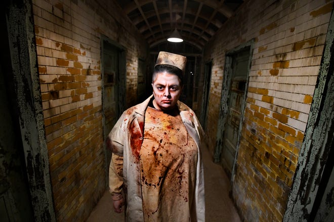 Scare actor Maria Mikulec means business, evil business during a preview of the Eloise Asylum in Westland, Michigan on September 23, 2021.