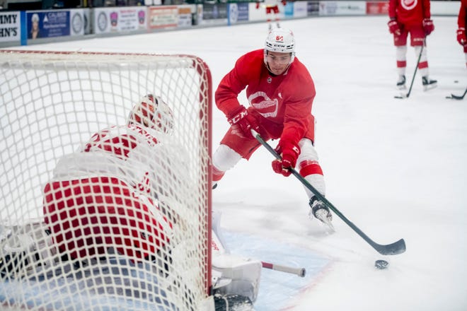 Left wing Luke Toporowski tries to get the puck past goaltender Victor Brattstrom during Red Wings training camp.