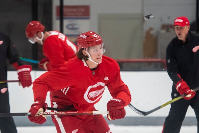 Defenseman Moritz Seider keeps his eyes on a flying puck during Red Wings training camp.