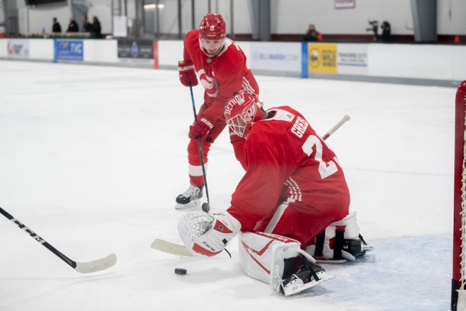 Goaltender Thomas Greiss stops a shot by right wing Filip Zadina during Red Wings training camp.