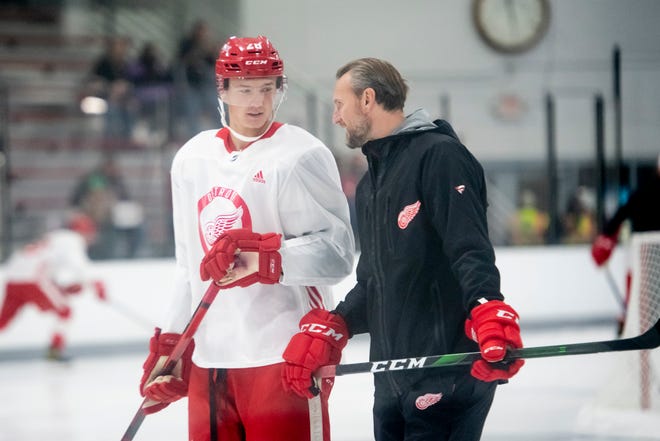 Defenseman Gustav Lindstrom chats with Niklas Kronwall, a former Red Wings defenseman and current manager of European player development during the Red Wings' training camp Friday, Sept. 24, 2021, at Centre Ice Arena in Traverse City.