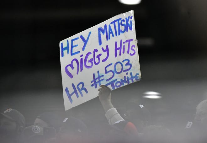 A fan holds up a message in the  first inning.