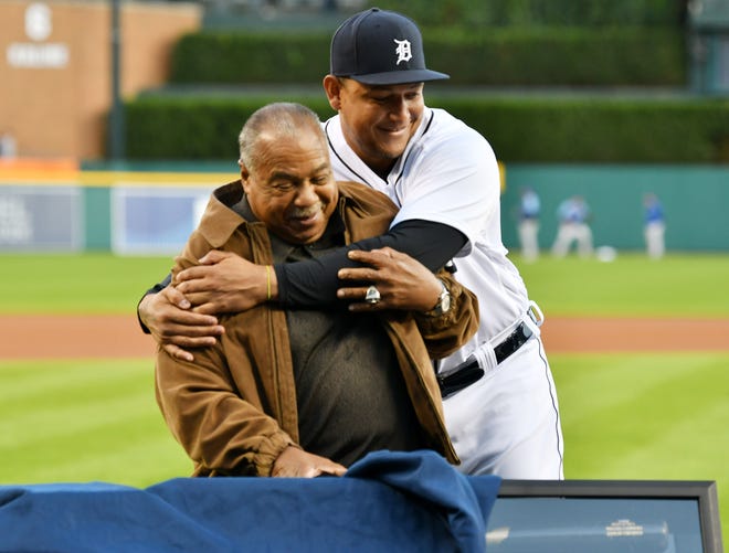 Tigers’ Miguel Cabrera hugs Tigers legend Willie Horton, left, as Horton tries to uncover a bat and batting gloves being given to Cabers during a special pregame ceremony celebrating Miguel Cabrera and his journey to 500 home run.