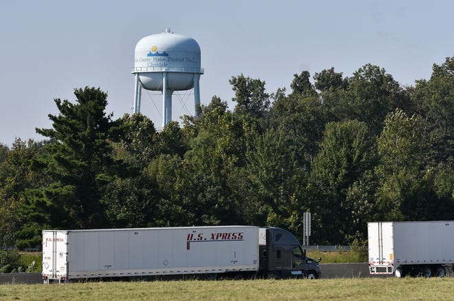 Trucks pass by on Interstate 65 in Glendale, Kentucky on Sept. 27, 2021. The water tower for the Hardin County Water District 2 Glendale is seen in the background.