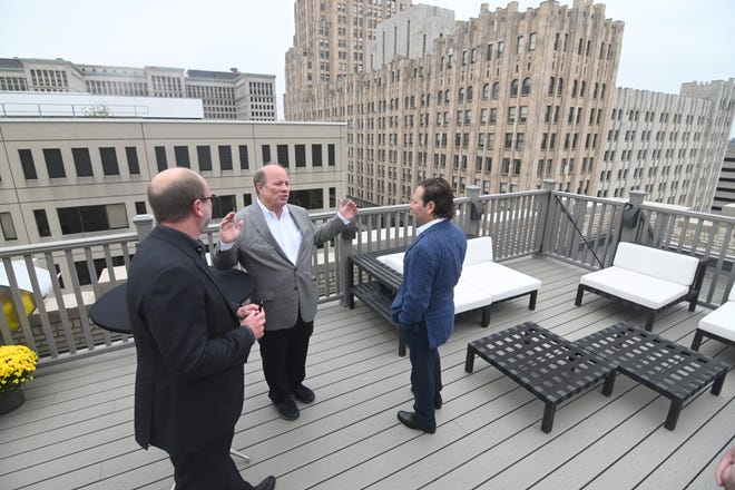 Developer Matthew Sosin, left, Detroit Mayor Mike Duggan and developer Adam Lutz, tour the 8th floor outdoor patio deck of the Albert Kahn Building apartment complex in the New Center area on Wednesday, October 6, 2021.