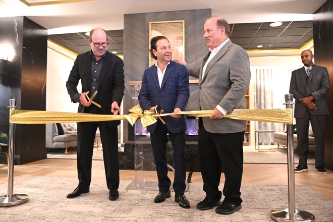 Matthew Sosin, left, and Adam Lutz, developers of The Kahn, join Detroit Mayor Mike Duggan during a ribbon cutting for the apartment complex in the New Center area on Wednesday, October 6, 2021.