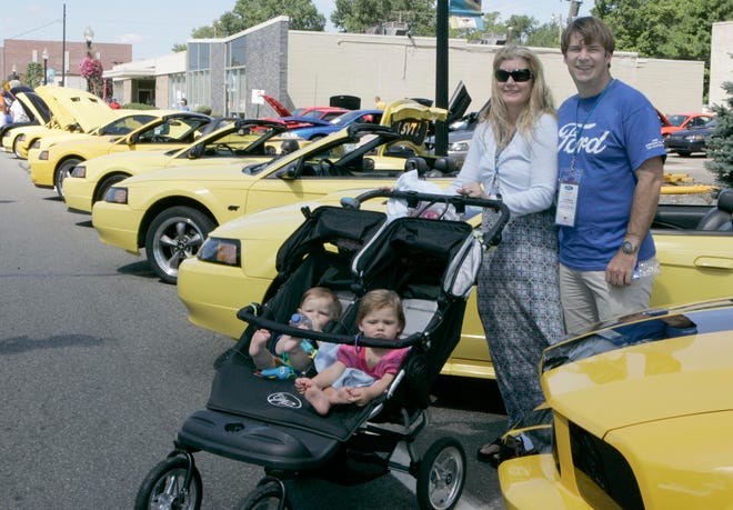 Ferndale,  Michigan:  Dream Cruisers.  Jim Farley a Ford Motor company Vice president and his family Lia (wife) and Jameson (left)  (9 months) and Jason (right) 19 months. of Birmingham. This is a  photo from Woodward and  9 mile in the Ford area called Mustang Alley. Where over 1000 Mustangs were on display.  This could be the largest gathering of Mustangs in one place, ever to be held.