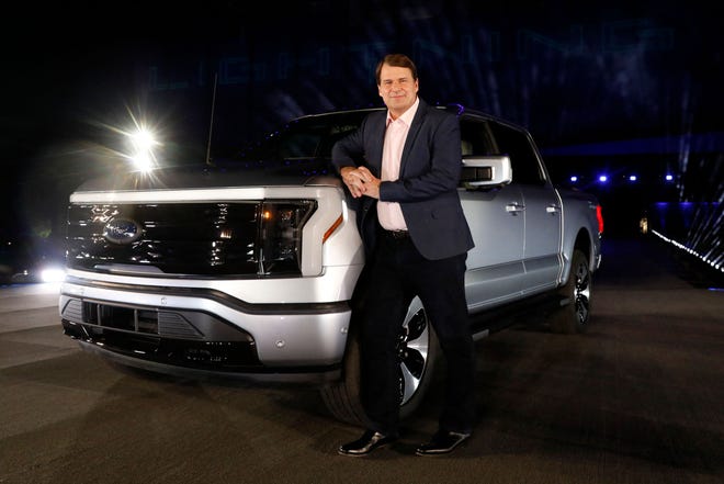 Ford Motor Company's chief executive officer Jim Farley poses next to the newly unveiled electric F-150 Lightning outside of their headquarters in Dearborn, Michigan on May 19, 2021. - One day after winning an enthusiastic endorsement from President Joe Biden, Ford will officially preview the all-electric version of its best-selling F-150 truck on May 19, 2021. The battery-powered Ford F-150 "Lightning" is part of the US auto giant's $22 billion campaign to ramp up its electric vehicle offerings by 2025.
