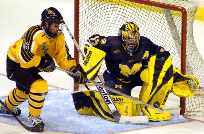 Michigan goalie Al Montoya, right, makes a save on Colorado College center Trevor Frischmon during the third period of the 2005 NCAA Midwest Regional hockey final in Grand Rapids, Mich.