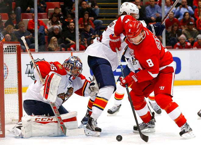 Florida Panthers goalie Al Montoya, left, stops a shot by Red Wings forward Justin Abdelkader as defenseman Aaron Ekblad defends in the second period of an NHL game in 2016 in Detroit.