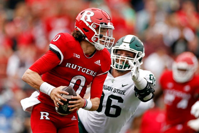 Rutgers quarterback Noah Vedral (0) gets away from a tackle attempt by Michigan State defensive end Jacub Panasiuk (96) during the second half.