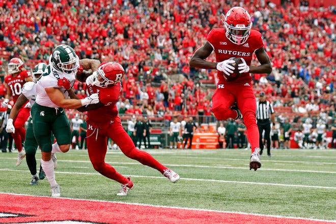 Rutgers wide receiver Aron Cruickshank, right, scores a touchdown against Michigan State during the first half.