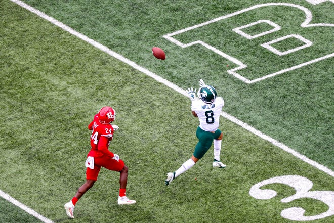 Michigan State wide receiver Jalen Nailor, right, beats Rutgers defensive back Patrice Rene to make a catch for a 65-yard touchdown during the second quarter.