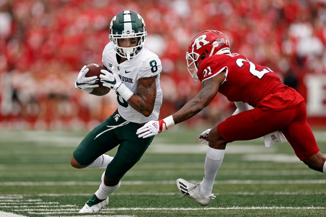 Michigan State wide receiver Jalen Nailor (8) is forced out of bounds by Rutgers defensive back Tre Avery during the first half.