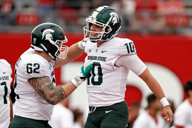 Michigan State quarterback Payton Thorne (10) celebrates a touchdown with Luke Campbell (62) during the first half.