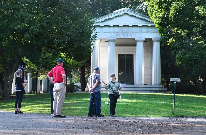 Kathleen Marcaccio, center, of Preservation Detroit, tells a brief  history at the J. L. Hudson crypt during a tour of the Woodlawn Cemetery in Detroit on Saturday, October 9, 2021.