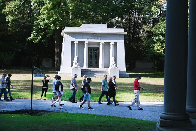 People walk past the Dodge Brothers crypt during a guided tour of Woodlawn Cemetery.