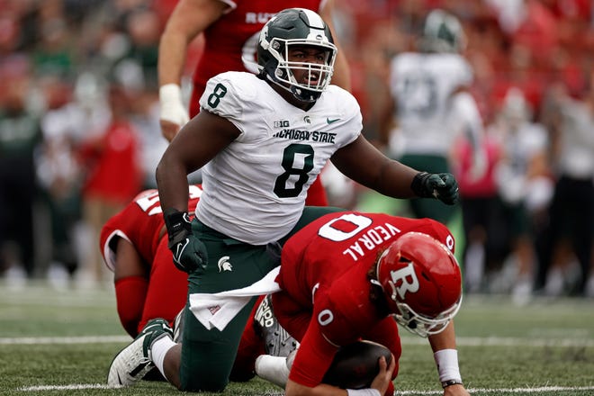 Michigan State defensive tackle Simeon Barrow (8) reacts after sacking Rutgers quarterback Noah Vedral (0) during the first half.