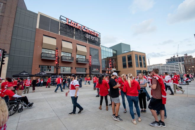 Fans hang out outside of Little Caesars Arena before the start of the game.